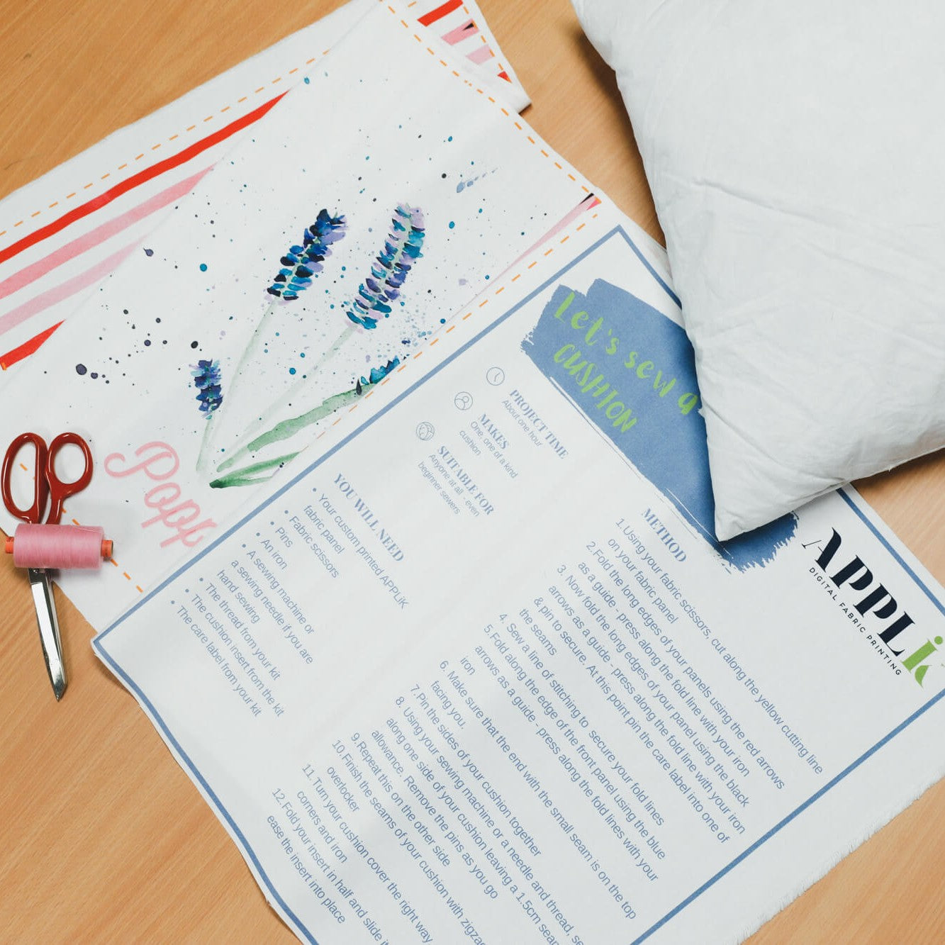Flatlay of Applik DIY sew your own cushion kit plus scissiors and thread.