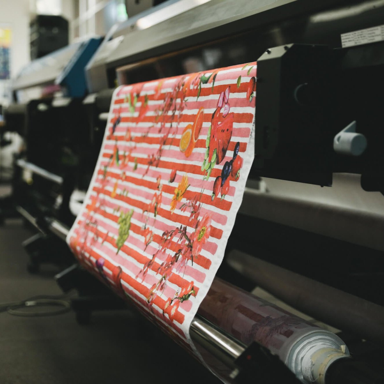 red and pink fabric coming off the APPLiK digital fabric printer