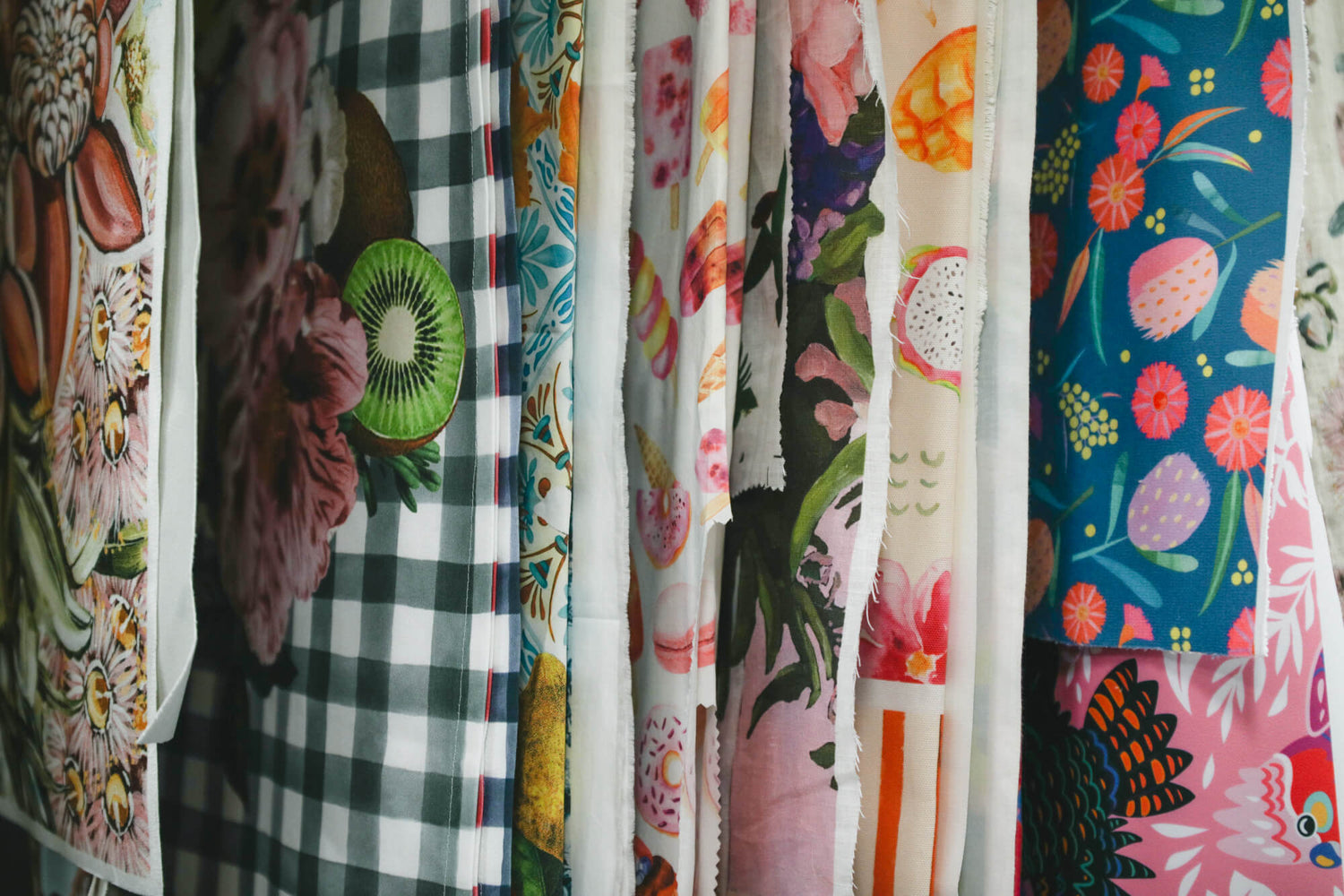 bright fabric with prints by various artists and creatives hanging