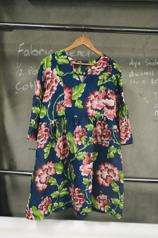 Navy smock dress with pink flowers and greenery.