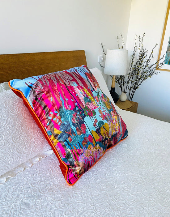 Lou Jaeger velvet cushion with piping on white bedspread.
