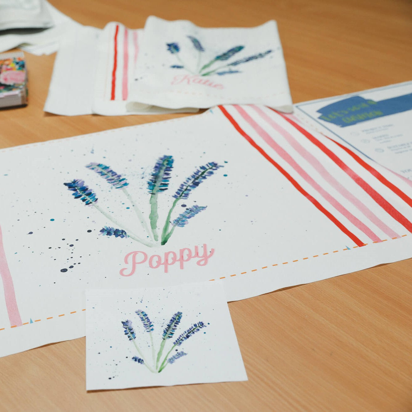 Sample artwork for DIY cushion kit. Lavendar flowers iwth the word "poppy" are printed on the front.