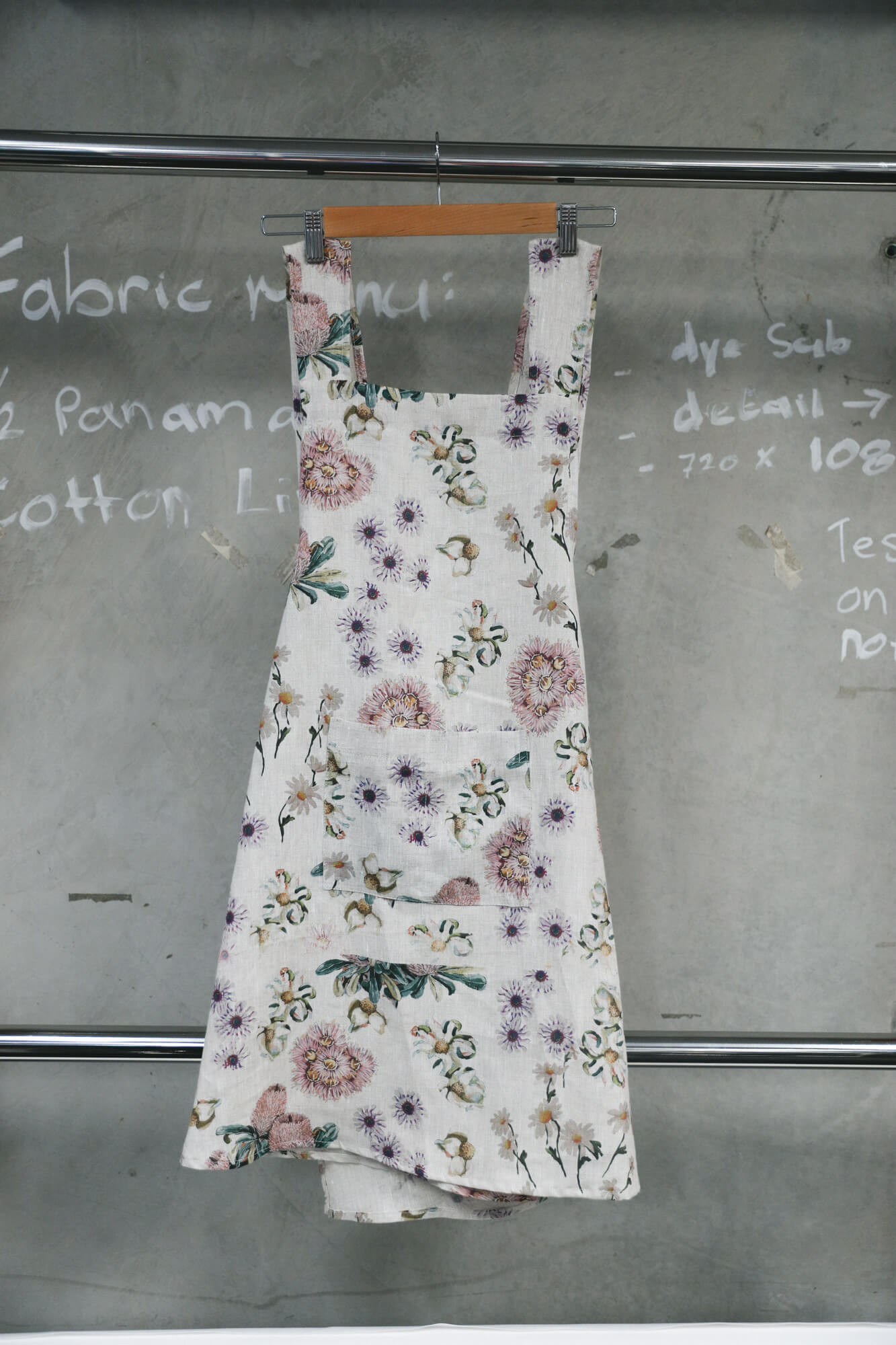 Front view of a linen cross back apron with large pocket.