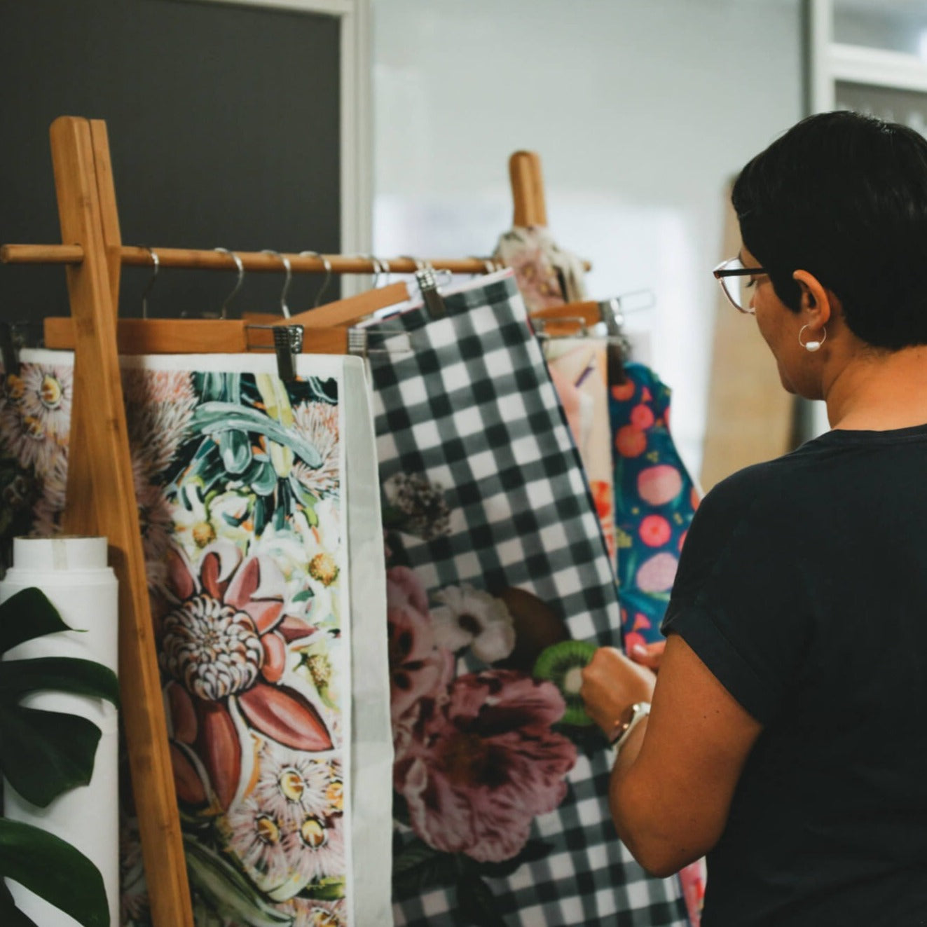 Rameez looking through collection of hanging digitally printed fabric at Brisbane studio.